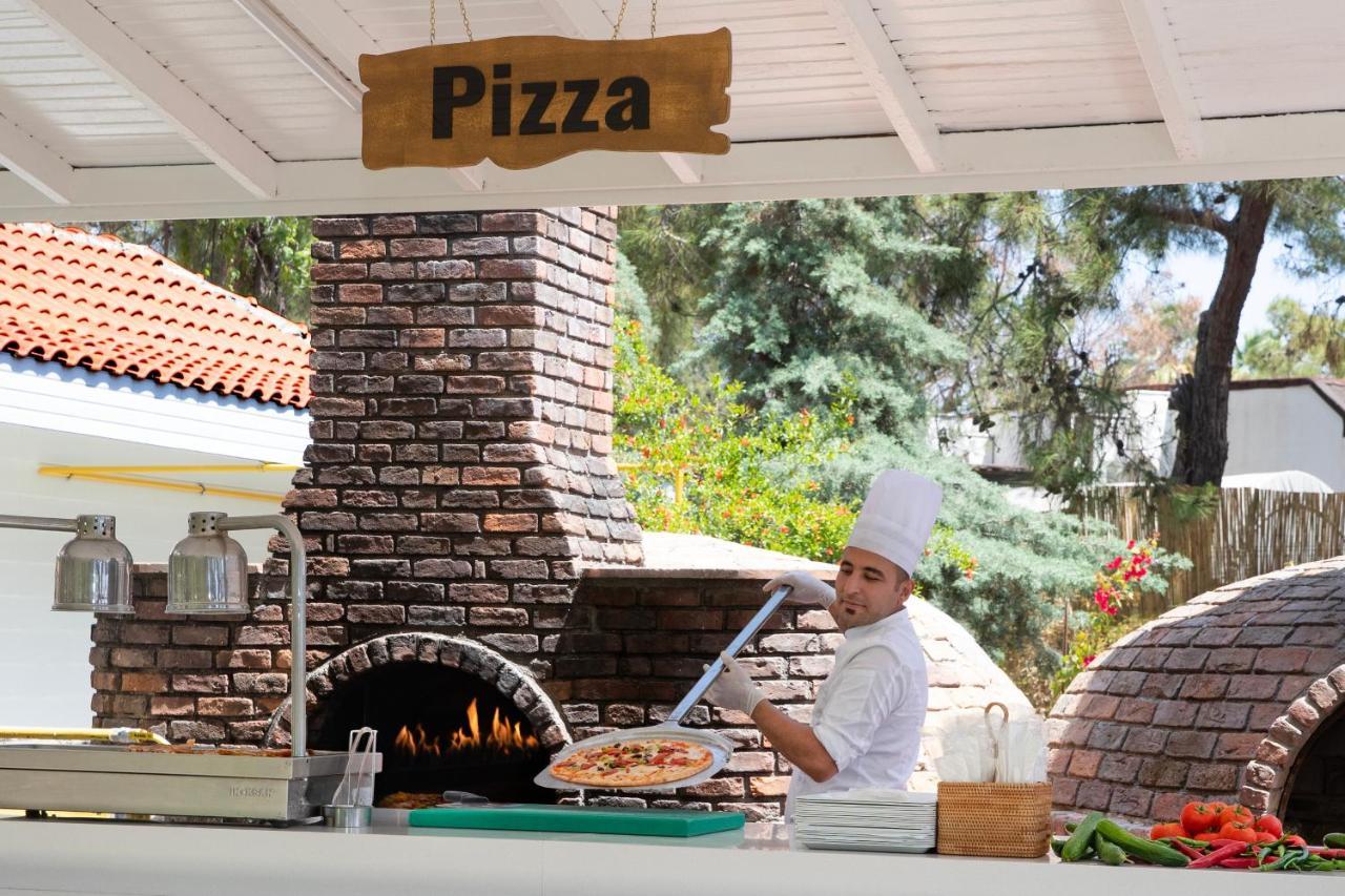 Marti Myra Hotell Tekirova Exteriör bild Pizza being prepared in a wood-fired oven